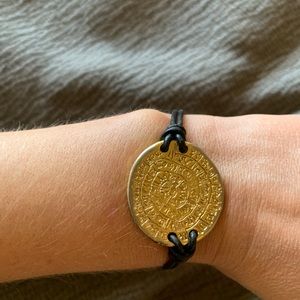 Gold and black leather bracelet.